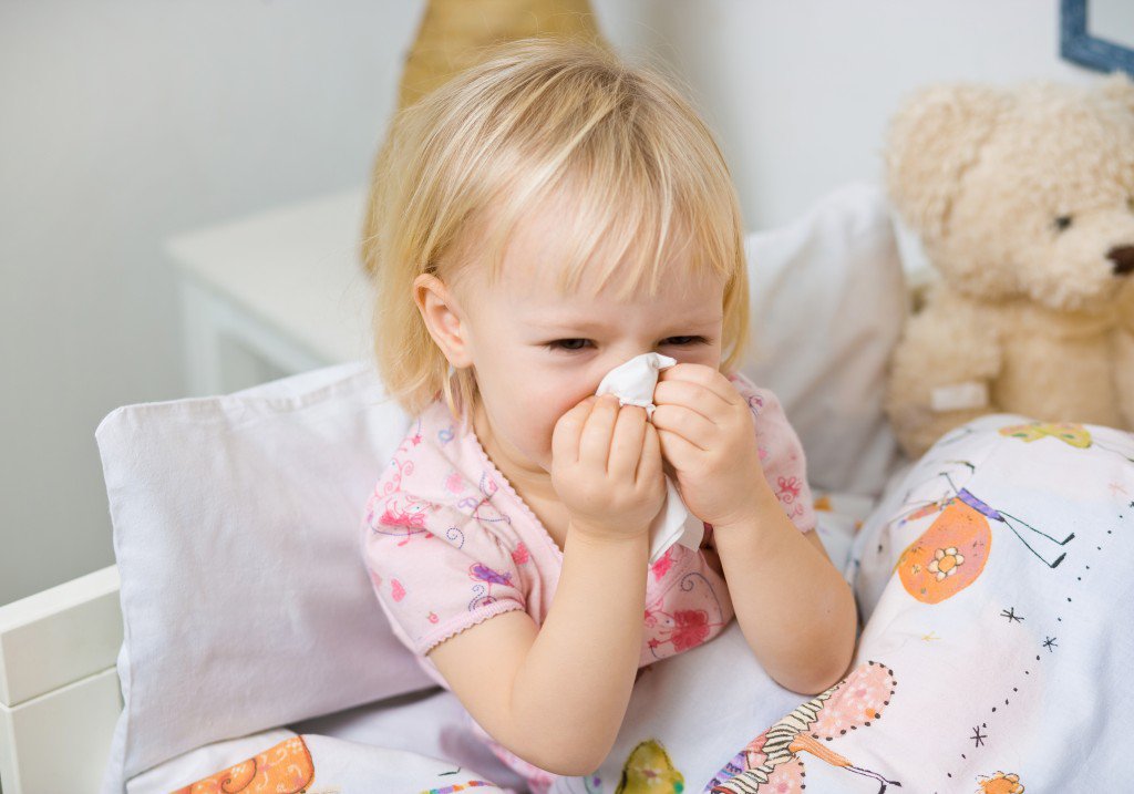 little girl in bed witch cold